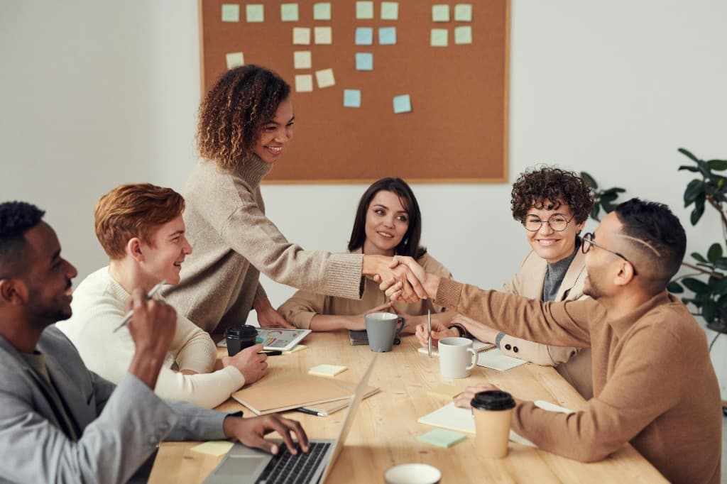 Professionals collaborating around a meeting table, brainstorming and planning in a modern consultancy environment
